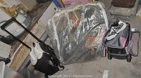 Photo showing the bedding set wrapped in plastic and two rolling cases with bowling balls and shoes on the floor
