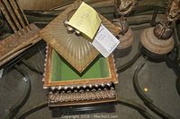 Photo showing decorative box with ornate carved details and green felt interior