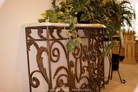 Front view of console table showing marble top and scrollwork base