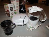 Image showing multiple kitchen appliances including Chefmate waffle maker, smoothie maker, pancake batter dispenser, and blender parts