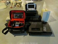 Lot of electronics including the printer, video camera in case, DVD player, speakers and 8 track player