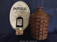 Full view of the advertising calendar with whiskey bottle display and ceramic crock side by side