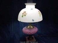 Full view of the vintage lamp showing the milk glass shade with floral decoration and pink hobnail glass body.