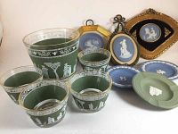 Overall group including ice bucket, four glasses, assorted jasperware plates and plaques on white background.