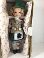 Full view of Shirley Temple doll inside original box showing detailed costume, hair, and overall condition of doll and protective packaging.