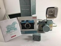 Diana Mini Latitude camera with detachable flash and instruction manuals in original box.