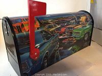 Side angle view of the mailbox showing classic car artwork and red flag.