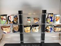 Full view of 12 Toby jugs arranged on acrylic stands showing multiple character designs and color schemes.