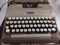 Close-up of the Eatons Prestige typewriter keyboard showing cream round keys and brand logo