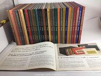 Photo showing 30 hardcover AutoMobile Quarterly magazine issues arranged side by side, illustrating colorful and diverse spines from 1966 to 1980.