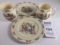 Photo showing two mugs and two plates with Bunnykins bunny character illustrations and bunny borders