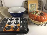 Photo showing Fire King milk glass pie dish, white milk glass mixing bowl, ceramic pumpkin pie dish with lid and a set of muffin top pans.