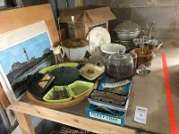 Overview of collection displaying the party trays, cookware, glassware, and framed print arranged on a table