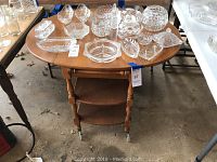 1960's wooden tea cart with drop leafs, some wear, with clear glass items on top (not included).