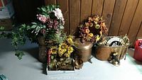 Overall view of the copper decor lot showing water trough, cider dispenser, floral decor, and brass items