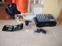 Wide view showing all items including mixing board, cassette decks, cameras, vintage phone, and accessories.