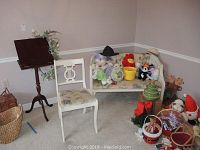 Full view showing dark brown wooden music stand, white wooden chair with floral padded seat, and matching wicker-backed padded bench with floral upholstery and white frame; stuffed toys and other items around the bench and chair.