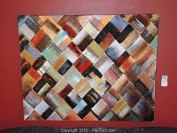 Full view of large textured abstract painting on red wall showing multicolored grid pattern and overall condition.