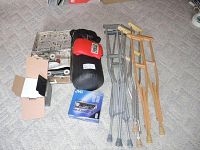 Lot contents including small Everlast punching bag, sparring gloves, Chicago leather roller skates, crutches, and car radio.