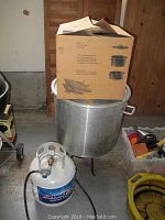 Large stainless steel pot on stand with AmeriGas propane tank visible