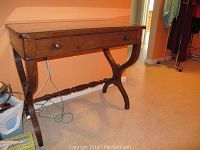 Full frontal view of antique mahogany vanity table showing the drawer and curved legs.