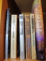 Books on shelf including Leap into Darkness, Desert Epistles, Foundation, The Tower of Shadows