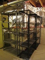 Photo showing all four metal shelving units standing side by side in basement, highlighting overall size and construction