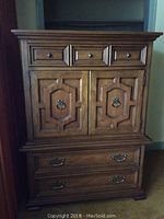 Front view of Malcolm wood dresser showing top three drawers and two cabinet doors below.