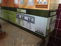 Boxed Home Collection Neptune vanity light fixture with three frosted glass shades and polished chrome finish, shown on packaging.