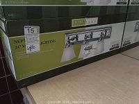 Boxed Home Collection Neptune vanity light fixture showing full front view of packaging with image of chrome fixture with three frosted glass shades.