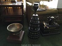Overall view of three trophies on green carpet in living room