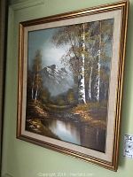 Framed oil painting hanging on wall showing full artwork and frame