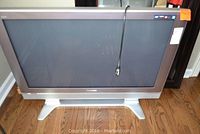 Front view of Panasonic 42-inch HDTV television on wooden floor, showing full front with screen and silver frame.