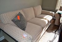 Front-right perspective showing entire sofa and included throw pillow