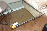Top view of the rectangular glass surface showing metal frame edges and circular center support of the base.
