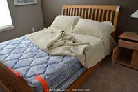 Bed frame with mattress, box spring, and bedding showing the entire bed and frame structure.