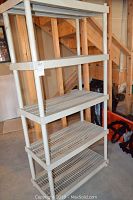 Beige plastic shelving unit with five slatted shelves measuring approximately 36x18x75 inches.