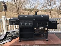 Full front view of the grill and smoker setup on deck with surrounding background