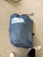 Gray Aerobed packed in carry bag with 'aero bed' logo visible. Shows item packed and condition.
