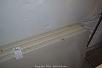 Three folding market tables stacked and shown in a storage area, showing plastic tops with some dirt and stains, with one photo focusing on edges and sides.