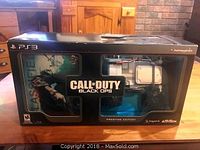 Photo of front box showing Call of Duty Black Ops Prestige Edition for PS3 with visible included accessories in packaging windows.