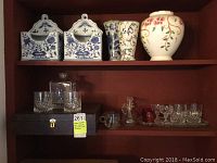 Shelf showing various ceramic vases (floral and blue-white) and wall hanging boxes, boxed Hoya crystal decanter and glasses, assorted glasses and small glassware items