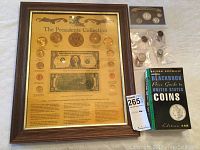 Framed Presidents Collection coin set, coin collecting book, and assorted coin packages on a table.