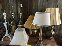 Photo showing all six lamps grouped together on wooden surface with varied bases and shades.