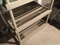 Close-up of slatted shelves showing grid design of plastic storage shelf unit.