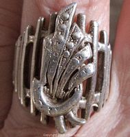 Top view of vintage silver modernist ring showing open work fan or feather motif design.