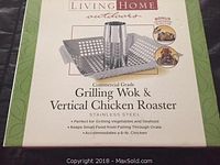 Box showing the Living Home commercial grade grilling wok and vertical chicken roaster with bonus seasoning injector. Stainless steel, accommodates a 6 lb chicken, keeps small food from falling through grate, ideal for grilling vegetables and seafood.