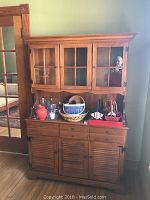 Front view of assembled two-piece hutch with items on shelves and top