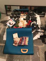 Front view of exercise equipment including dumbbells, mat, DVDs, and resistance bands.