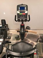 Front view showing console with controls, handlebars, and seat